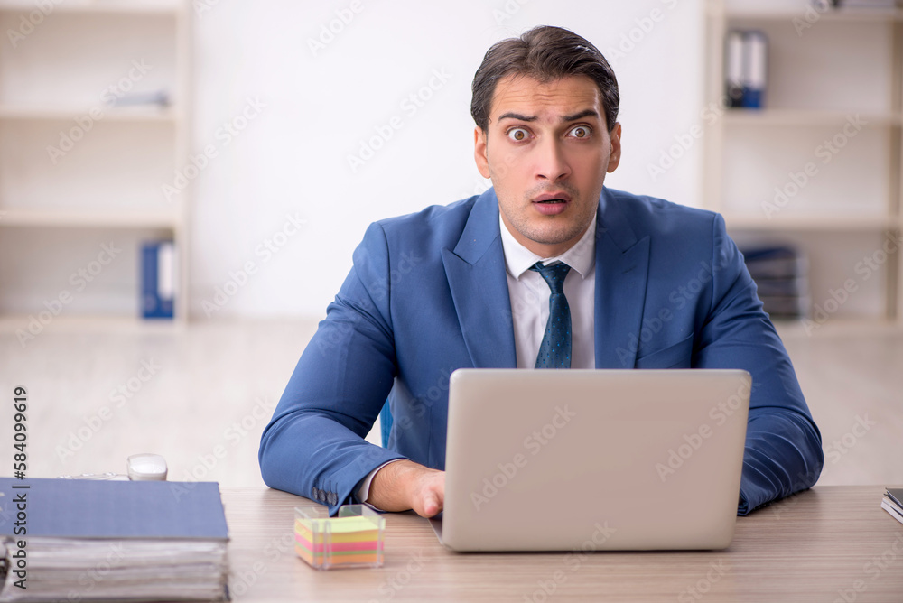 Young male employee working in the office Young male employee working in the office