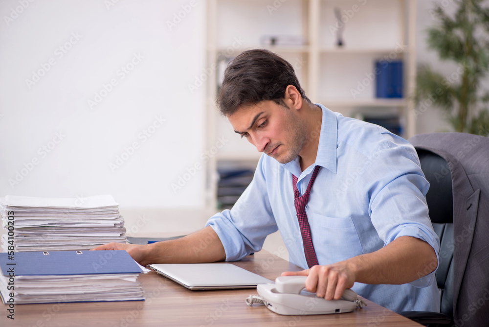 Young male employee working in the office Young male employee working in the office