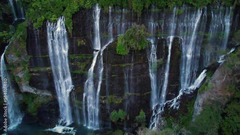 wide aerial pull away of a waterfall in Michoacán Mexico surrounded by lush green tree's. wide aerial pull away of a waterfall in Michoacán Mexico surrounded by lush green tree's.