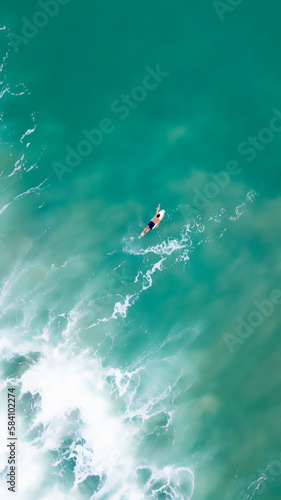 Aerial photography in Costa Rica, surfer alone int the ocean with big waves and amazing colors photo