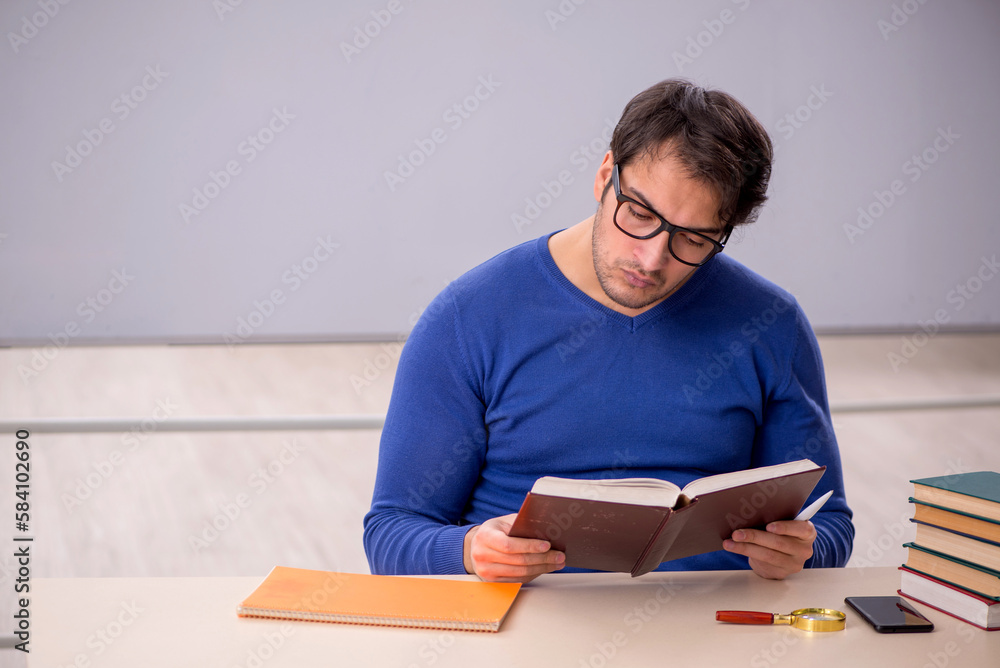 Young male student preparing for exams in the classroom Young male student preparing for exams in the classroom