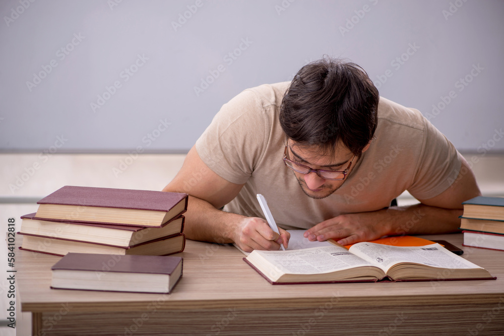 Young male student sitting in the classroom Young male student sitting in the classroom