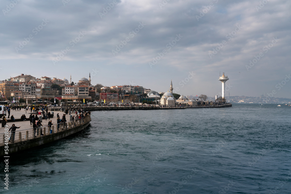 View of the Uskyudar district in the Asian part of Istanbul and the Shemsi Ahmed Pasha Mosque from the Bosporus water area on a sunny day, Istanbul, Turkey