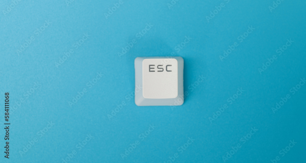 Keyboard Esc button on blue background Keyboard Esc button on blue background
