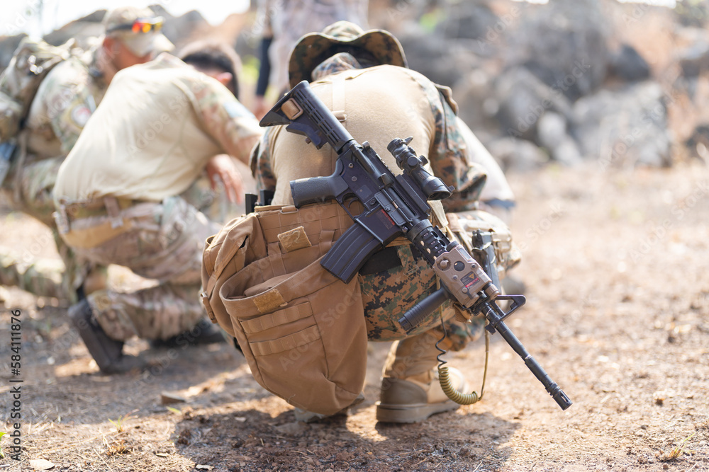 Fototapeta premium Team of U.S. Army marine corps soldier military war with gun weapon participating and preparing to attack the enemy in Thailand during exercise Cobra Gold training in battle. Combat force.