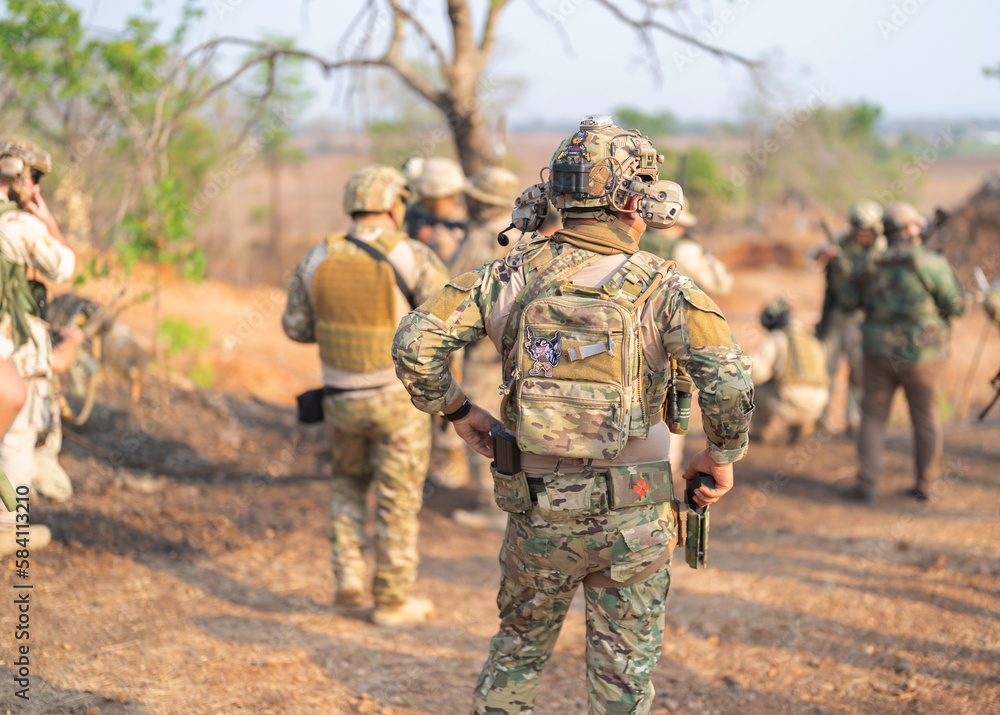 Team of U.S. Army marine corps soldier military war with gun weapon participating and preparing to attack the enemy in Thailand during exercise Cobra Gold training in battle. Combat force. Team of U.S. Army marine corps soldier military war with gun weapon participating and preparing to attack the enemy in Thailand during exercise Cobra Gold training in battle. Combat force.