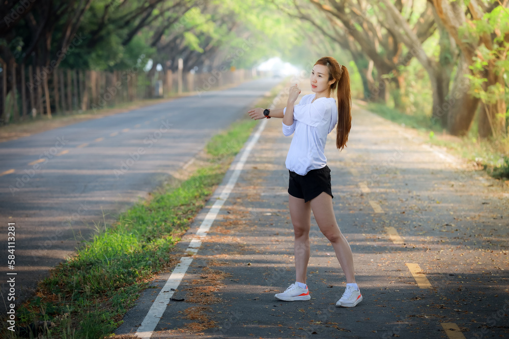 Young woman runner running on garden road,woman fitness silhouette sunrise jogging workout wellness concept. Young woman runner running on garden road,woman fitness silhouette sunrise jogging workout wellness concept.