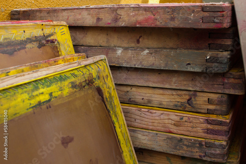 Wooden used screen printing frames stacked