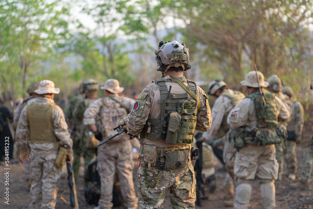 Team of U.S. Army marine corps soldier military war with gun weapon participating and preparing to attack the enemy in Thailand during exercise Cobra Gold training in battle. Combat force.