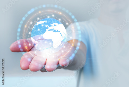 Businessman holding in hands with 3d translucent global and connection line graphics. Energy saving and clean energy around the world concept.