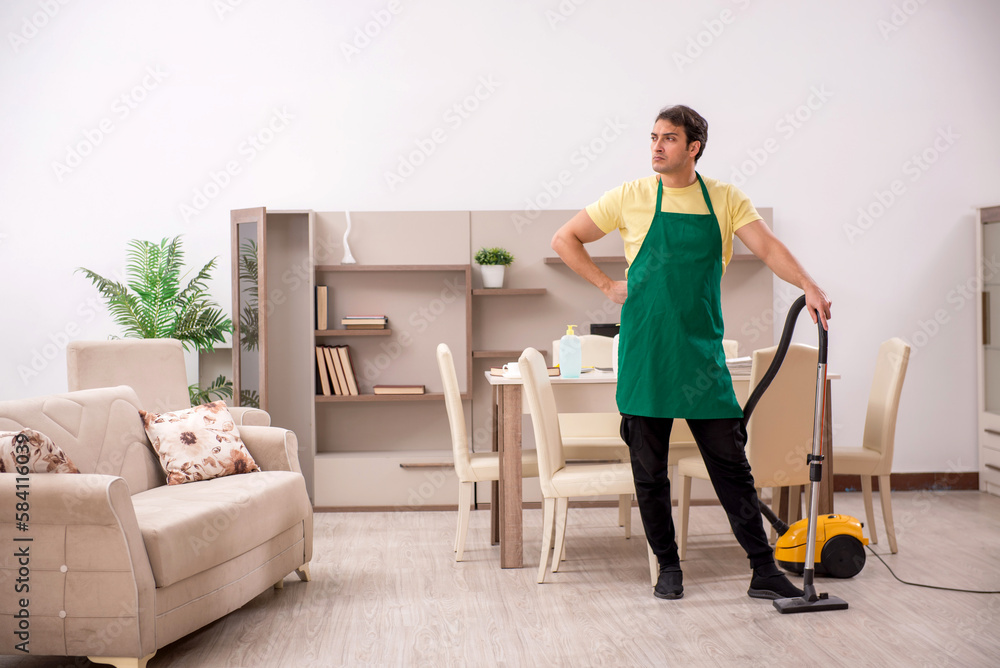 Young man doing housework indoors Young man doing housework indoors