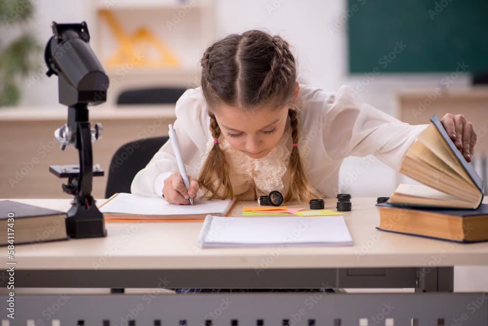 Small girl studying in the classroom Small girl studying in the classroom