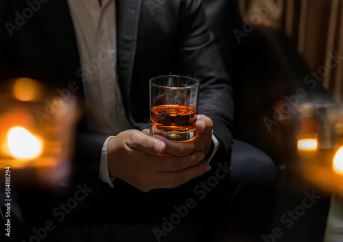 businessmen holding a glass of whiskey