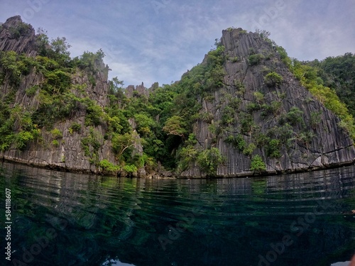 Majestic rocks in Coron  Palawan in the Philippines that are overgrown with shrubs and rise out of the water.
