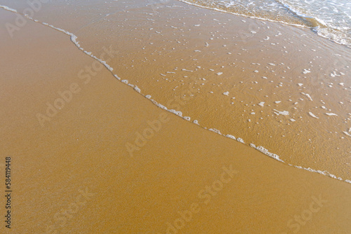 Beach with wave and blue sea water background