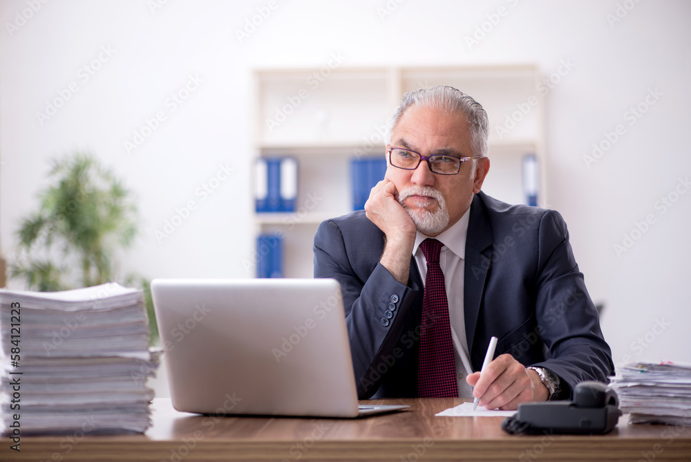 Old male employee and too much work in the office Old male employee and too much work in the office