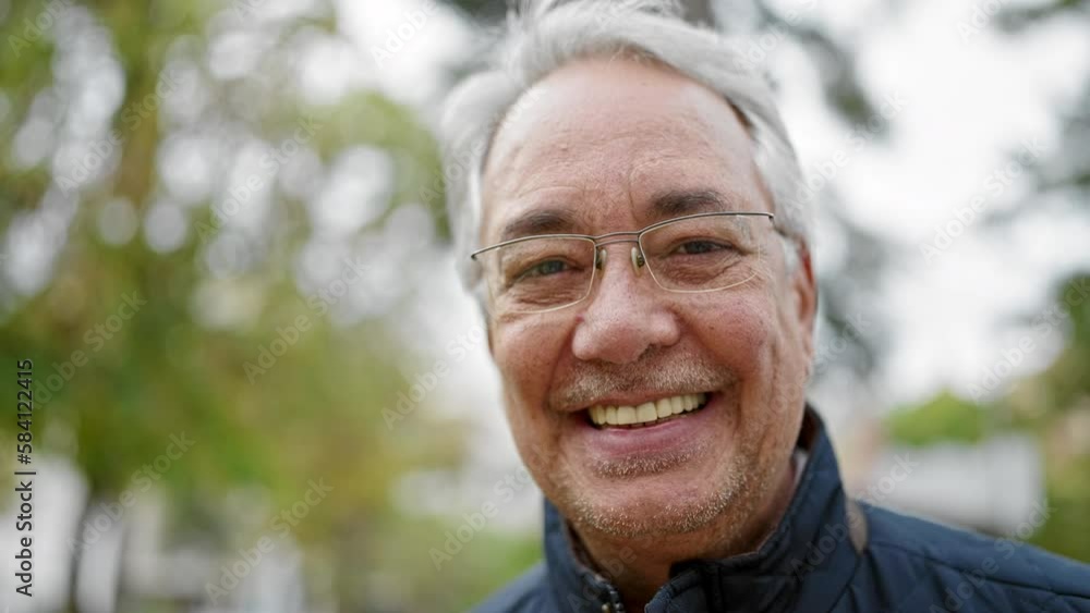 Middle age man with grey hair smiling confident at park Middle age man with grey hair smiling confident at park