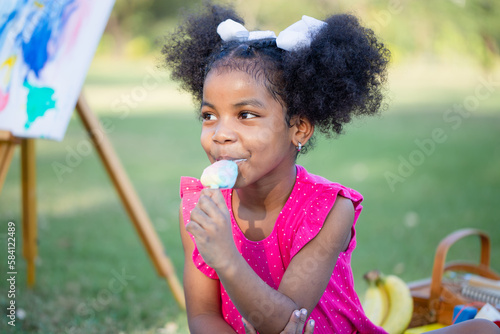 Cute little girl play in the garden  Pretty baby girl kid eating ice cream  Child girl playing outdoors