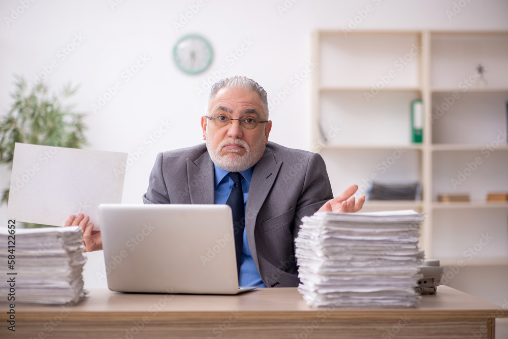 Old male employee and too much work in the office Old male employee and too much work in the office