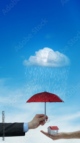 Toy umbrella over model house
