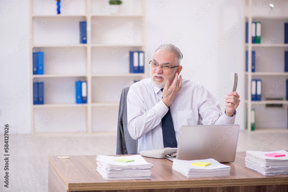 Old male employee and too much work in the office Old male employee and too much work in the office