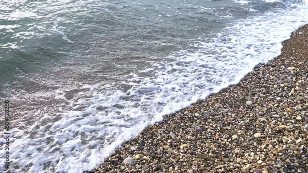 Powerful sea waves are crashing on the Black Sea coast. Waves splash on the beach with pebbles during a storm. Storm at sea. Panoramic view of the Black Sea. Russia. Sunset on the beach. 4K Powerful sea waves are crashing on the Black Sea coast. Waves splash on the beach with pebbles during a storm. Storm at sea. Panoramic view of the Black Sea. Russia. Sunset on the beach. 4K