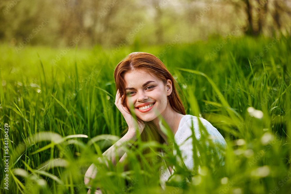 happy smiling redhead woman resting sitting in tall grass happy smiling redhead woman resting sitting in tall grass