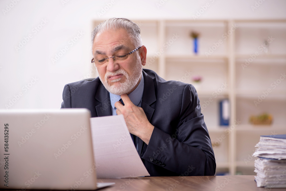 Old male employee and too much work in the office Old male employee and too much work in the office