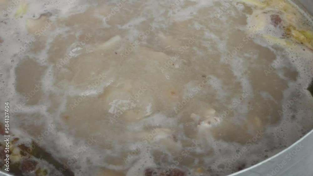Cooking chicken coconut soup or Tom kha gai , Thai famous food, Traditional food cooking concept, Boiling soup. Cooking chicken coconut soup or Tom kha gai , Thai famous food, Traditional food cooking concept, Boiling soup.
