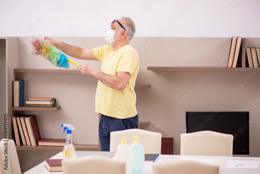 Old man doing housework at home Old man doing housework at home