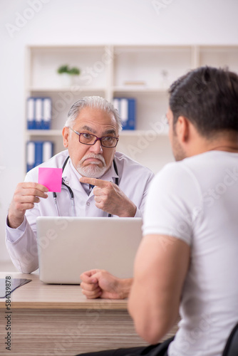 Young male patient visiting old male doctor