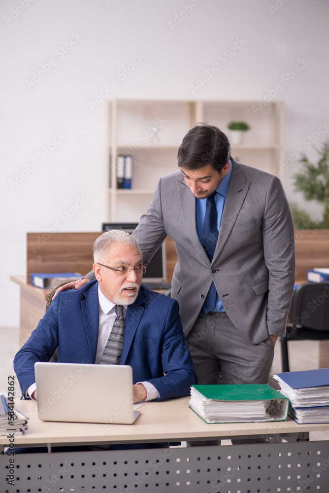 Two male colleagues working in the office Two male colleagues working in the office