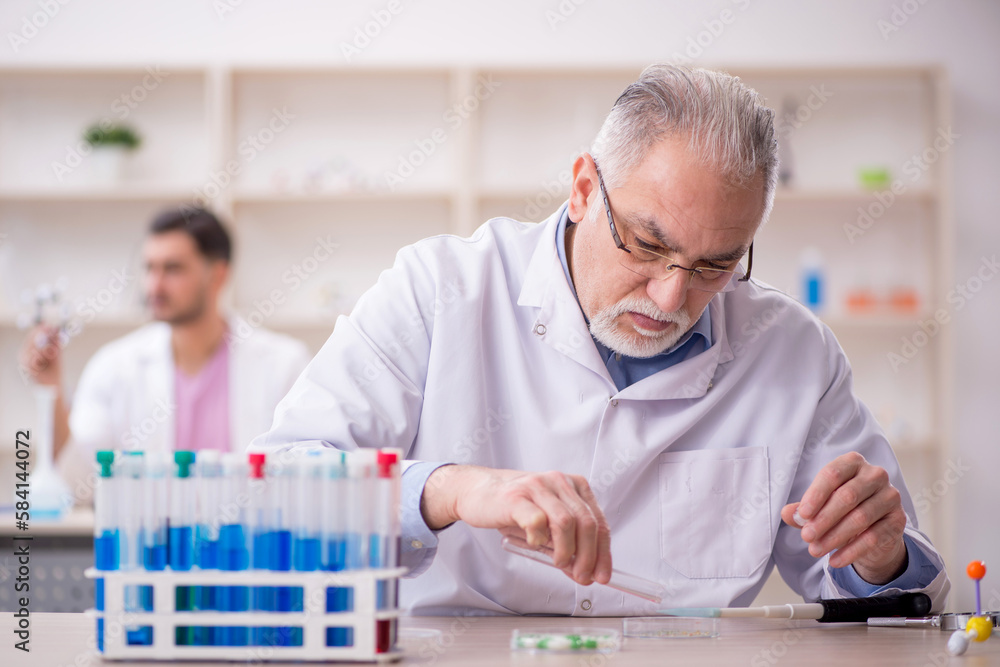 Two male chemists working at the lab Two male chemists working at the lab