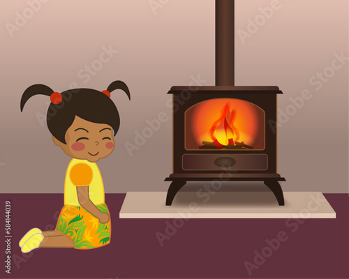 暖炉と少女。暖かな部屋でニッコリ笑顔