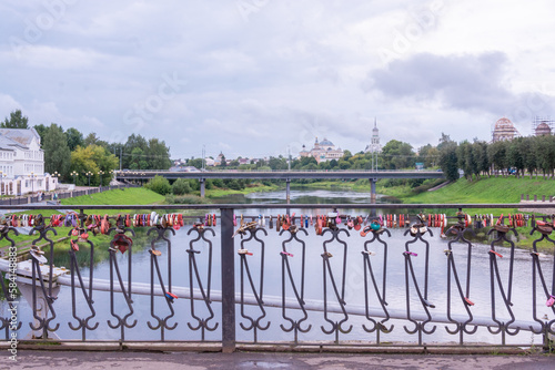 Tver region, the city of Torzhok. A bridge over the Tvertsu River, hung with wedding castles. photo