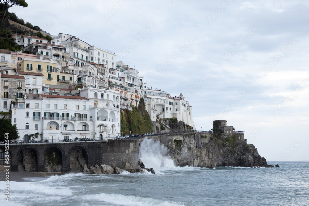 Amalfi coast in Italy with strong waves and overcast sky