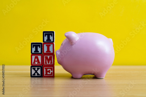 Tax time text with piggy bank