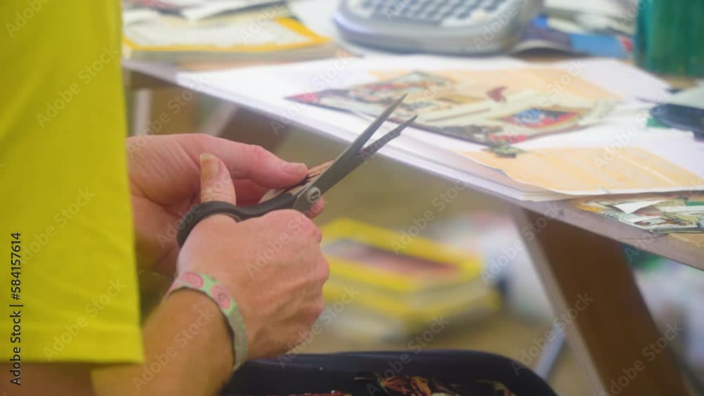 teenager in creative arts class is cutting various different types of newspapers and magazines putting together unique pieces of images and text close up hands summer music festival teenager in creative arts class is cutting various different types of newspapers and magazines putting together unique pieces of images and text close up hands summer music festival