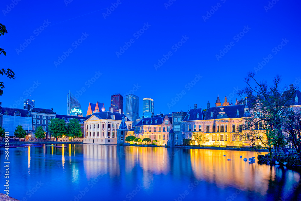 Binnenhof Palace of Parliament in The Hague in The Netherlands at Blue Hour.Skyscrapers Skyline On The Background.