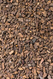 Closeup Image of Background Made of Pile of Colorful Brown, Yellow and Red Crushed Stone