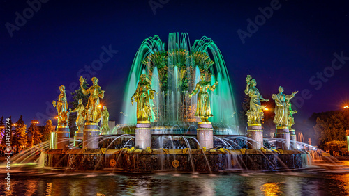 Moscow, Russia - Central fountain in VDNKh exhibition centre built in 1954 illuminated at night