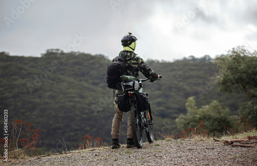 Man with a mountain bike, in camouflage clothes, bike packing on top of a hill in Adelaide, South Australia