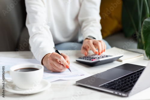 Business woman calculating balance prepare tax reduction income, cost budget expenses for pay money form personal Individual Income Tax Return photo