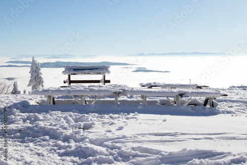 Ideal place with benches and wooden tables at the top of Lysa Hora for breakfast at sunrise and catching vitamin D. Czech Republic  Europe