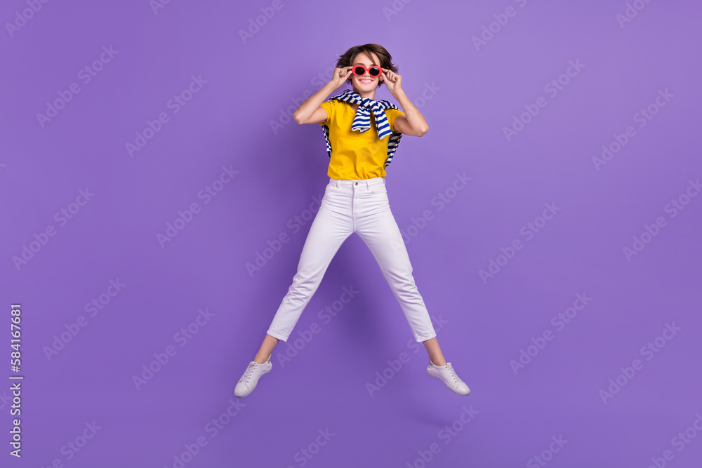 Full length photo of positive cheerful lady wear comfort bright clothes good mood have fun cool party isolated on purple color background Full length photo of positive cheerful lady wear comfort bright clothes good mood have fun cool party isolated on purple color background