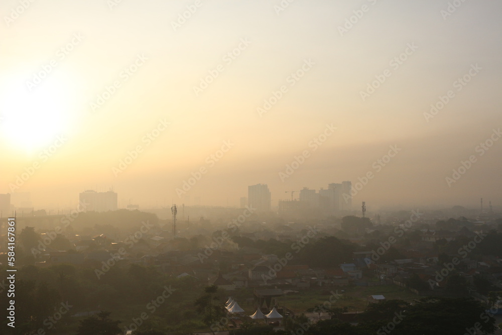 The view of the sunrise in the middle of the city seen from above,