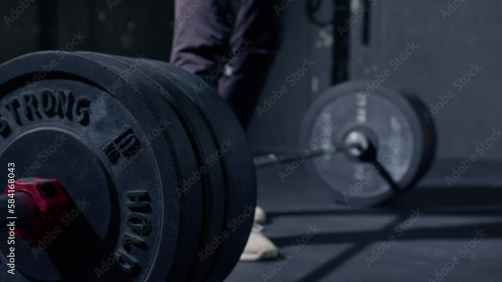 Man dropping the bar with high weight to the floor after doing deadlift. Slow motion Man dropping the bar with high weight to the floor after doing deadlift. Slow motion