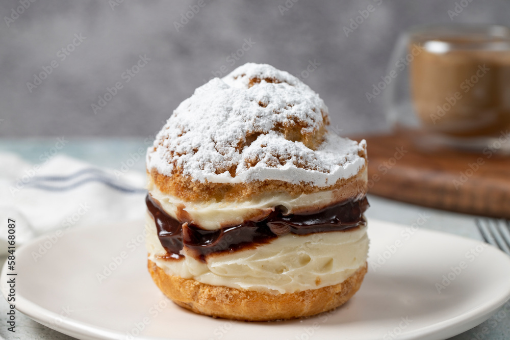 Cake with cream and liquid chocolate filling. Powdered Sugar Cake. Close up. Cake with cream and liquid chocolate filling. Powdered Sugar Cake. Close up.