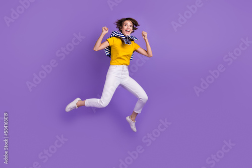 Full length photo of adorable cheerful lady wear stylish clothes celebrate sale low prices empty space isolated on purple color background