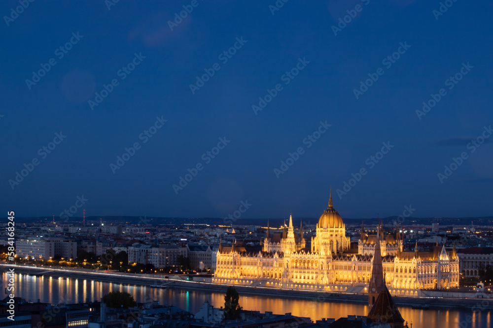 Fototapeta premium Budapest parliament illuminated at night and Danube river, Hungary